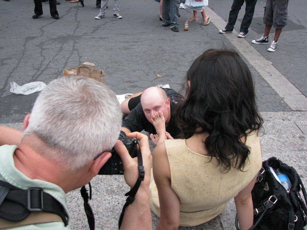 Creepy guy kissing bottom of woman's foot in public