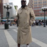 Man poses in overcoat