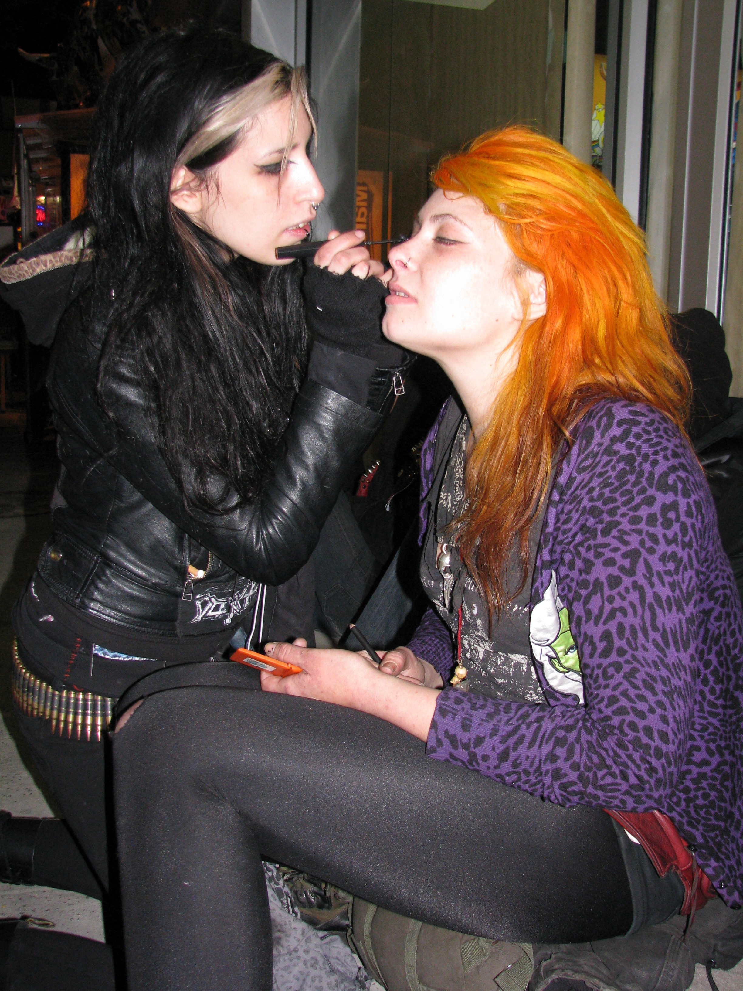 metal girls putting makeup on