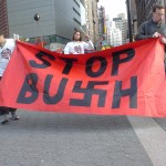 Demonstrators with STOP BUSH sign