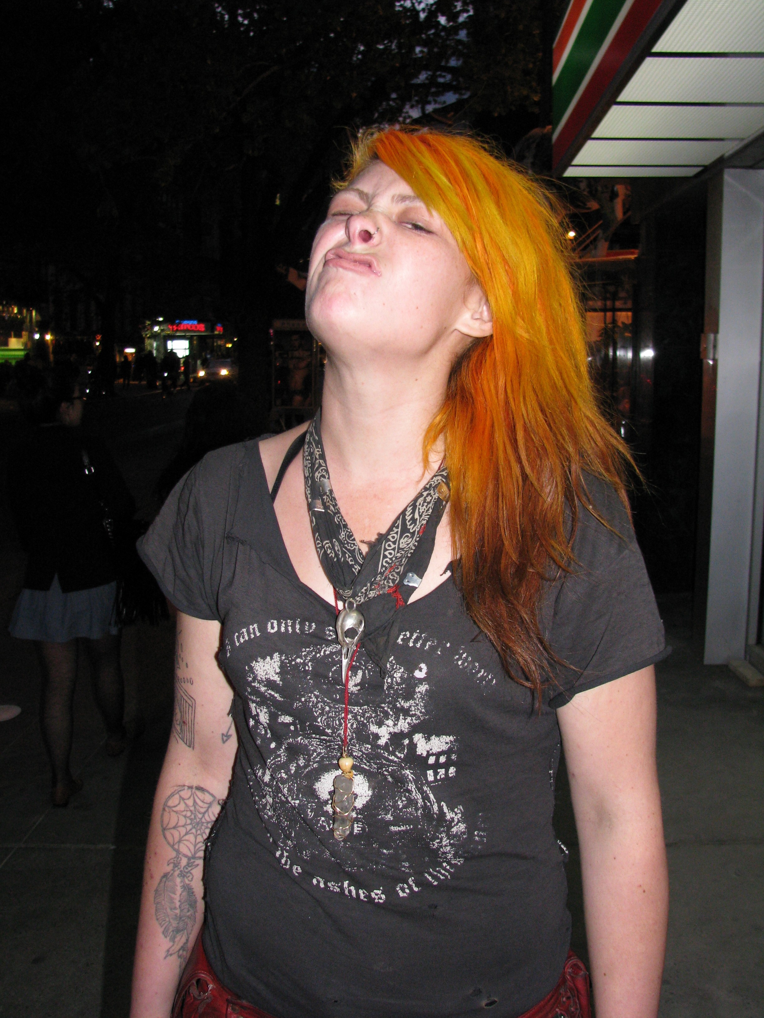 punk rock girl with orange hair looking tough