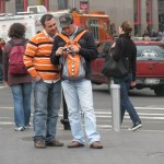 Tourists in orange wearing backpack in front so as not to get robbed