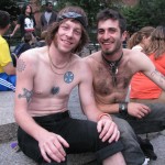 two shirtless gay men at park