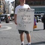 man with LOWER AGE OF CONSENT sign