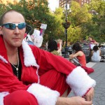 Man dressed as Santa and shades