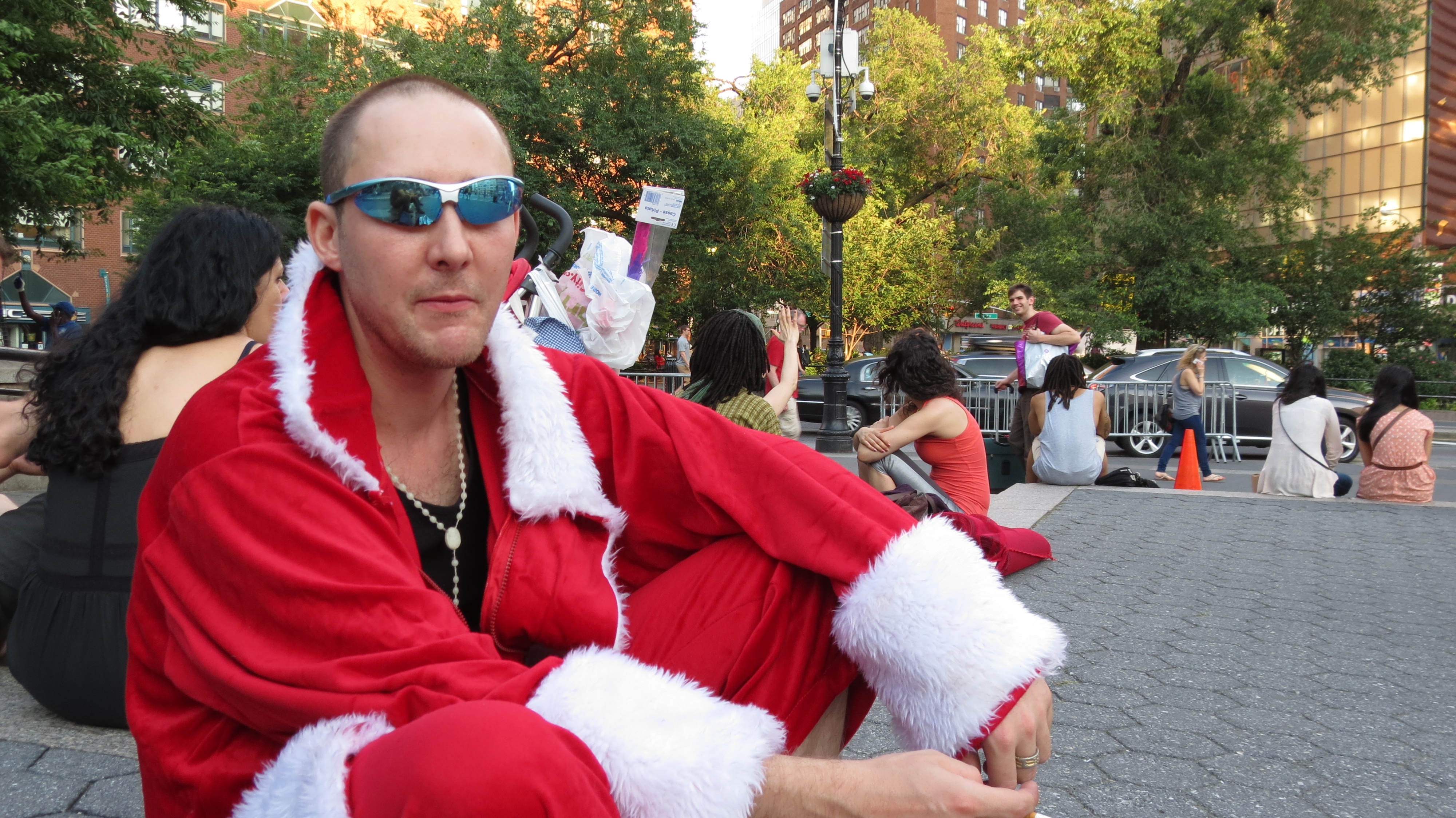Man dressed as Santa and shades