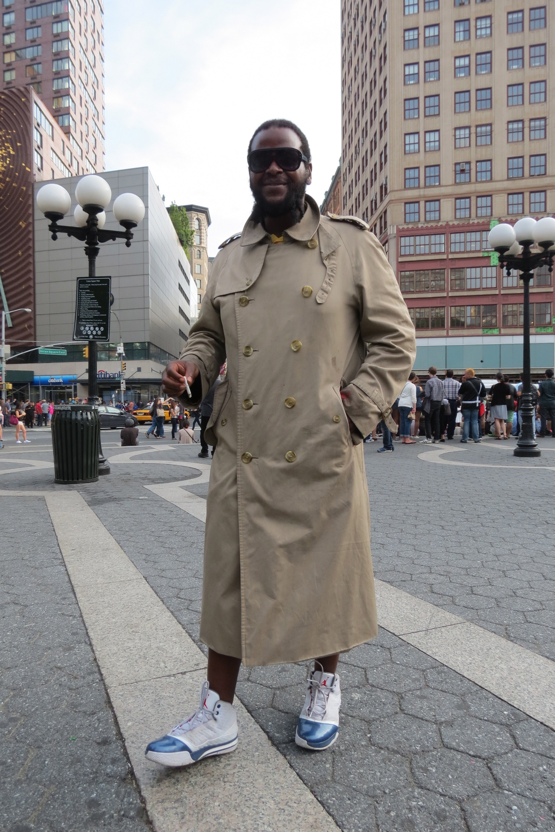 Man poses in overcoat