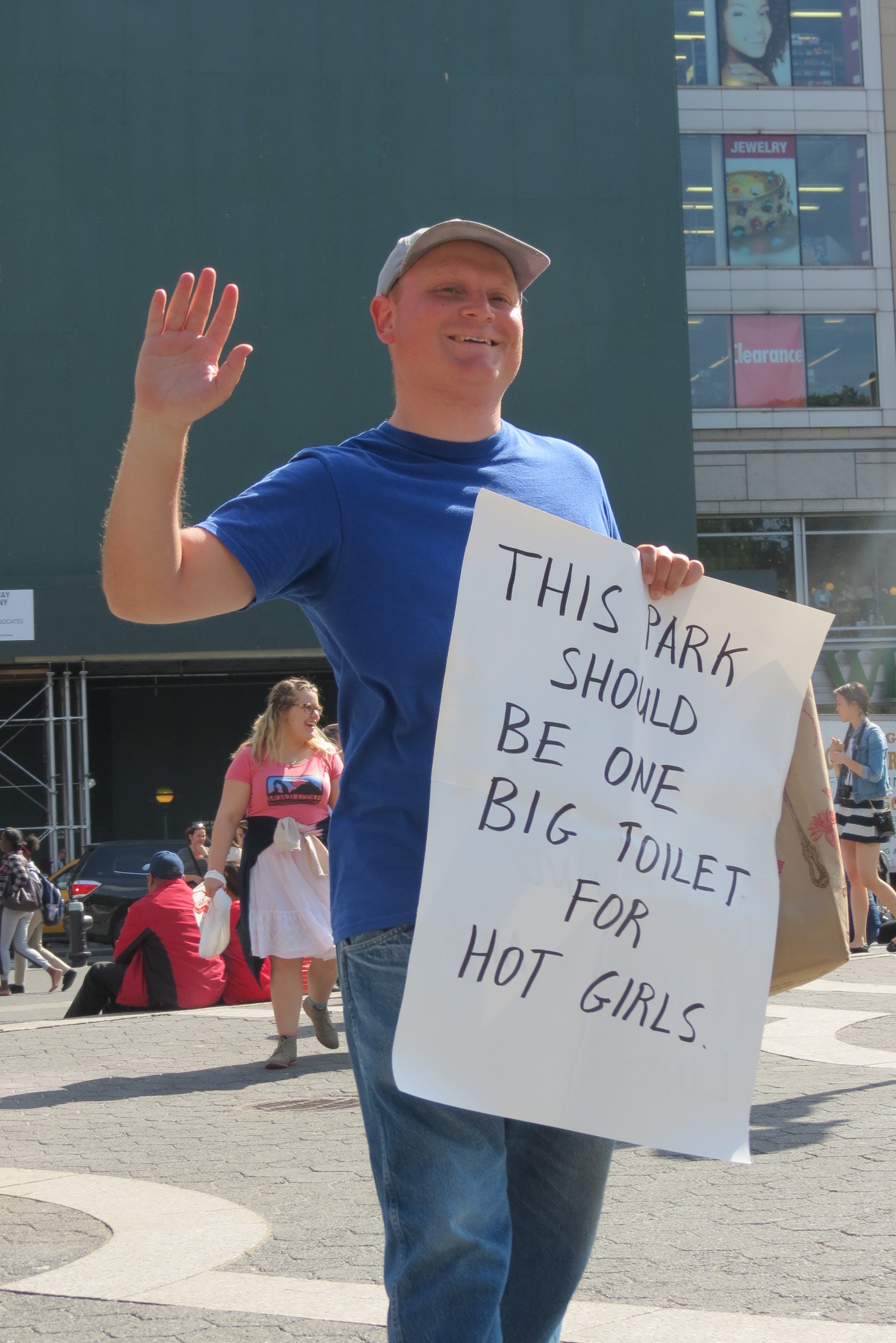 man with funny sex sign waving