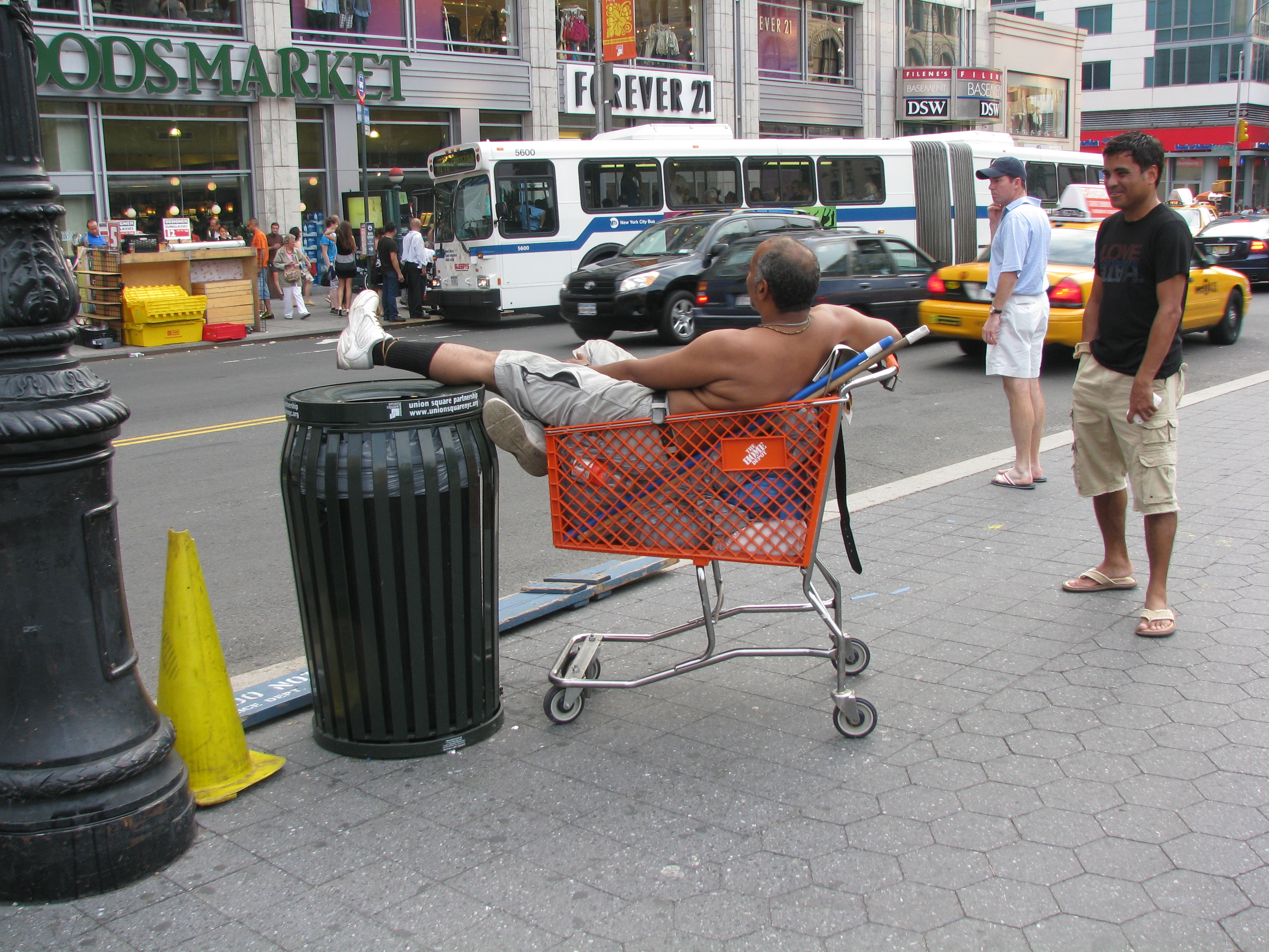 Man lounging in Shopping Cart Aug 24, 2009