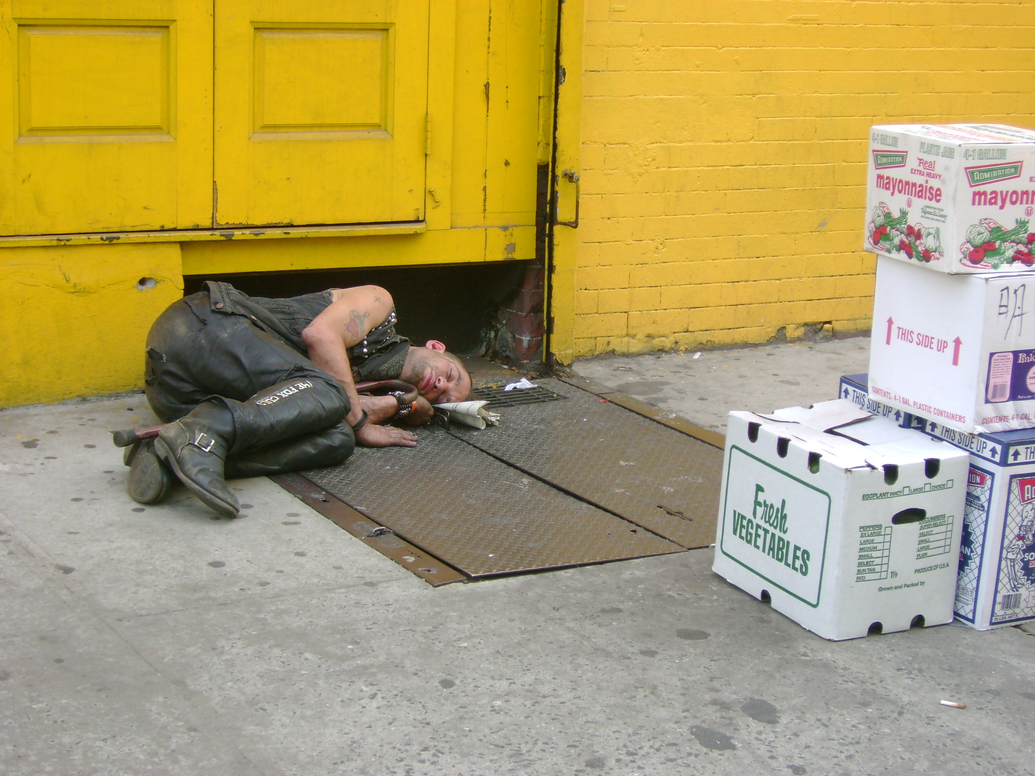 Homeless punk asleep on street