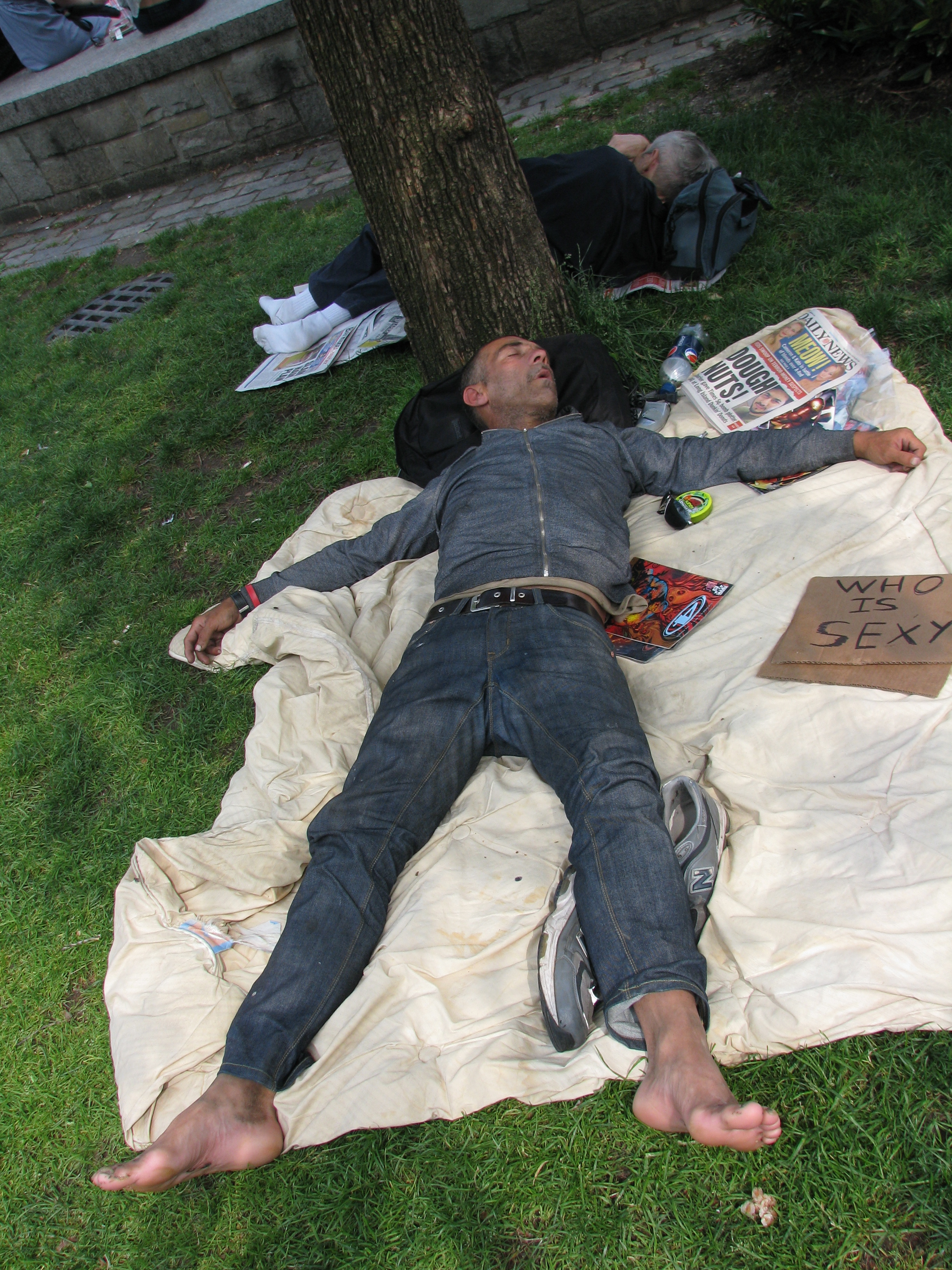homeless man sleeping in park
