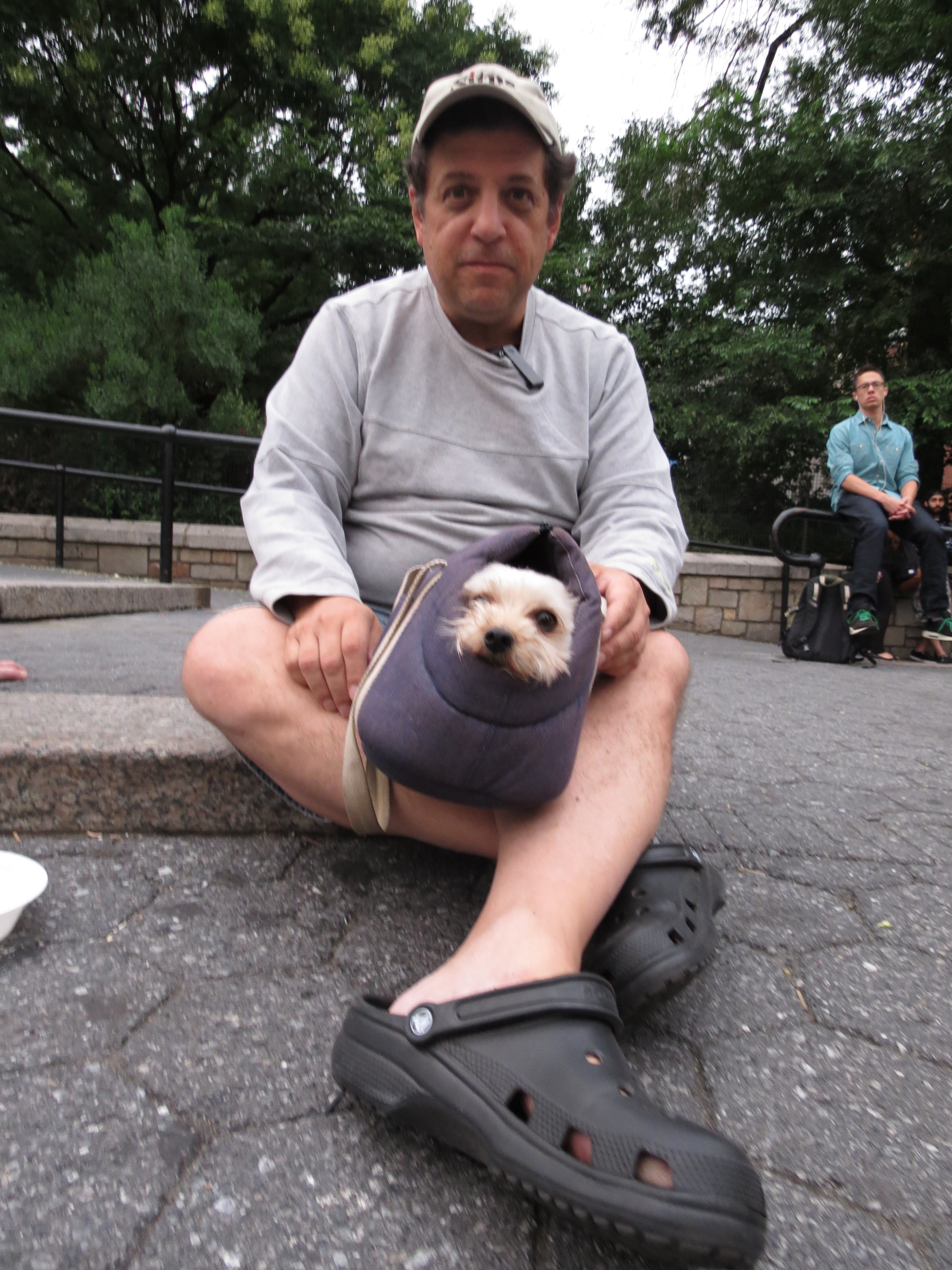 Man in Crocks with Dog in Case