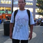Man wearing shirt with Swastika & other symbols
