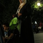 Muslim woman with phone tucked in headdress