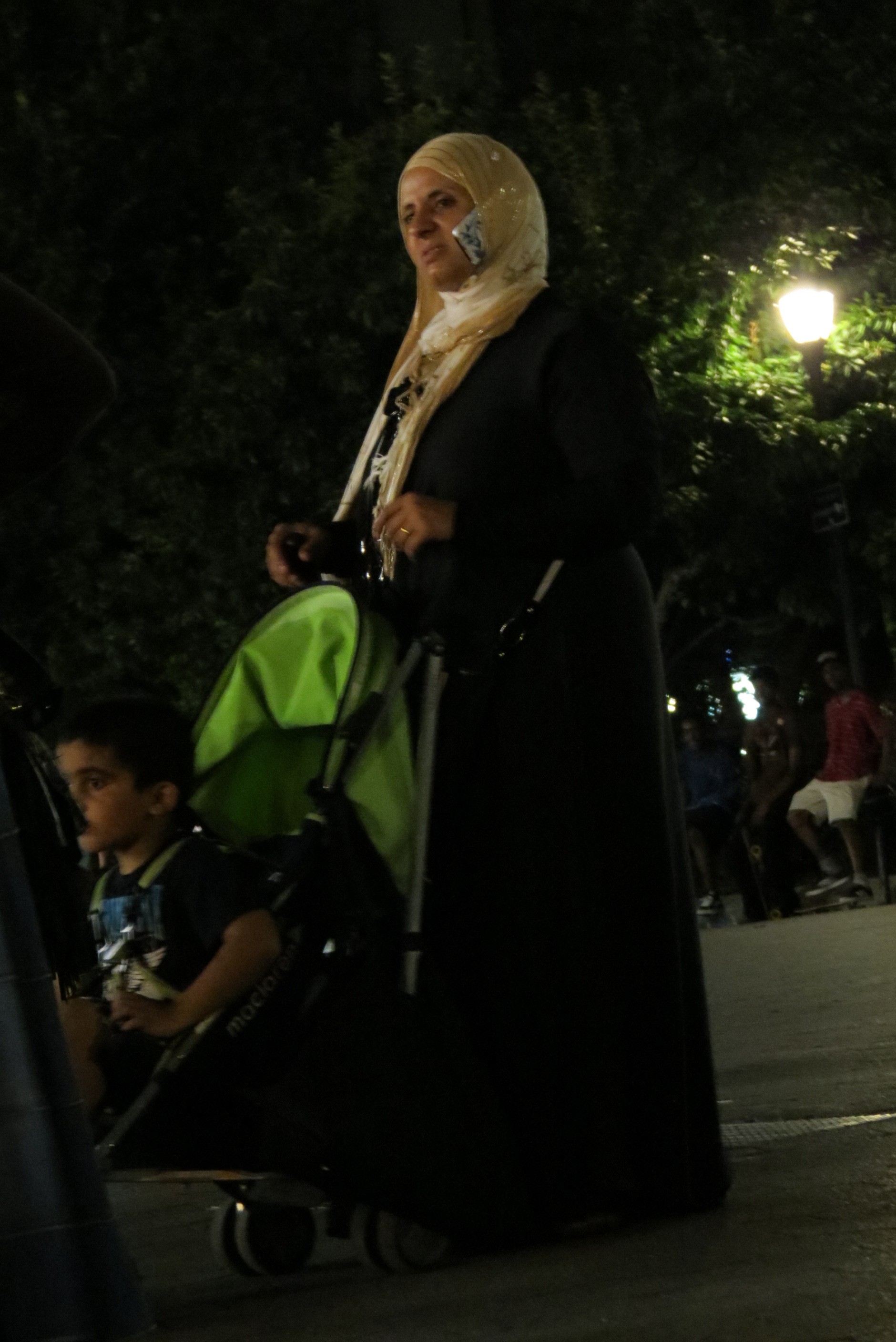 Muslim woman with phone tucked in headdress