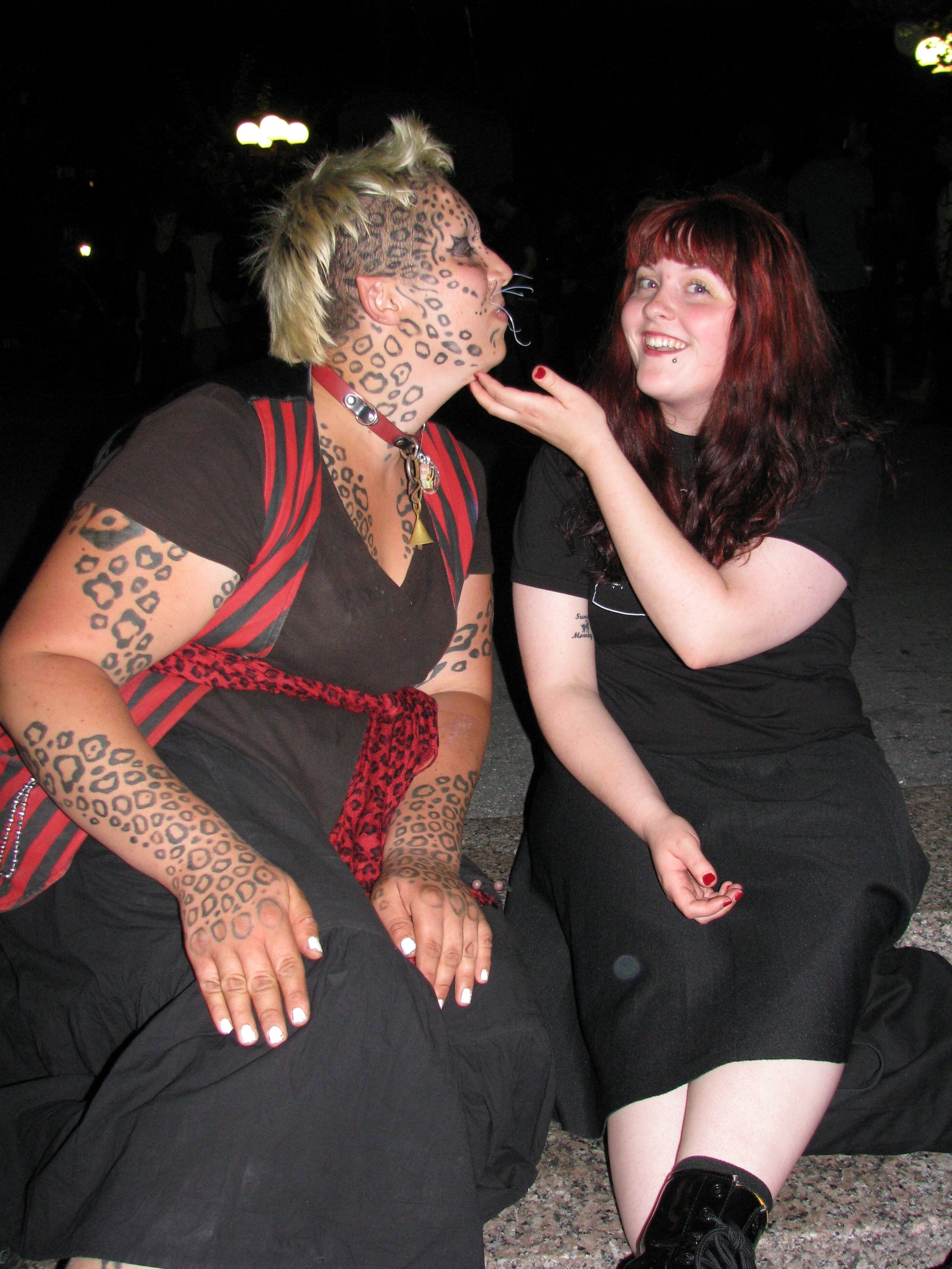 redhead scratching tattooed cat woman under chic
