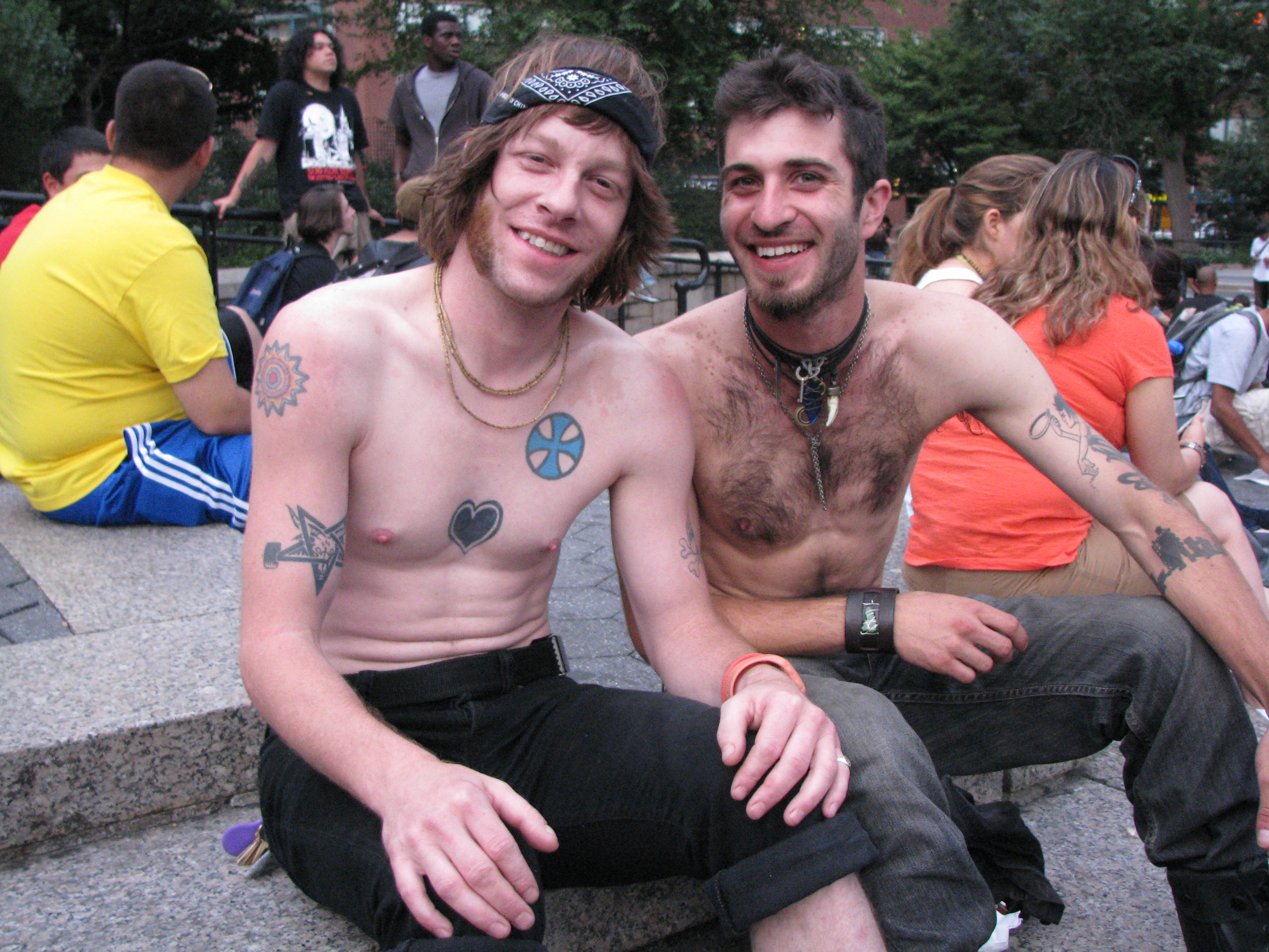 two shirtless gay men at park