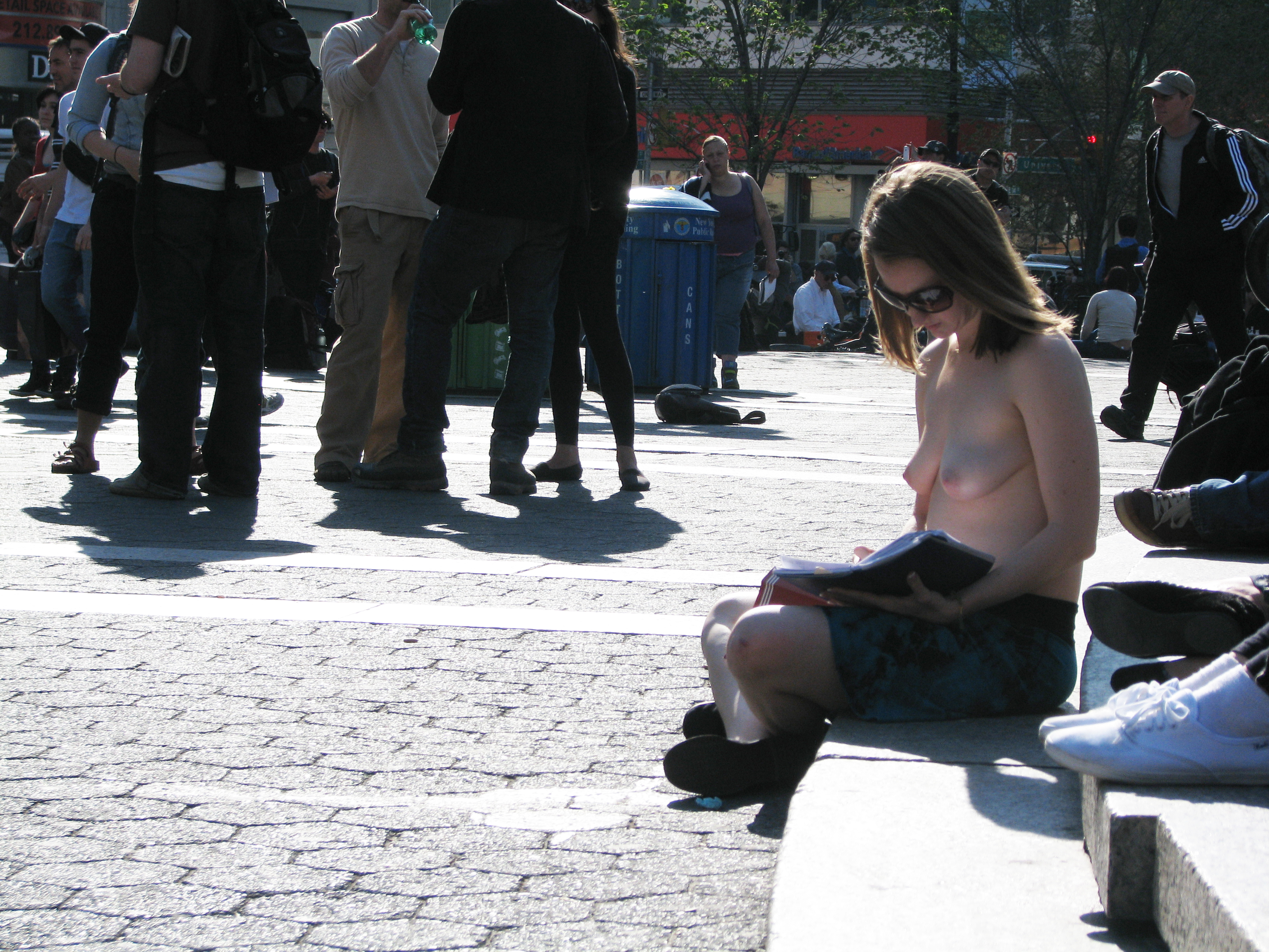 reading topless in park