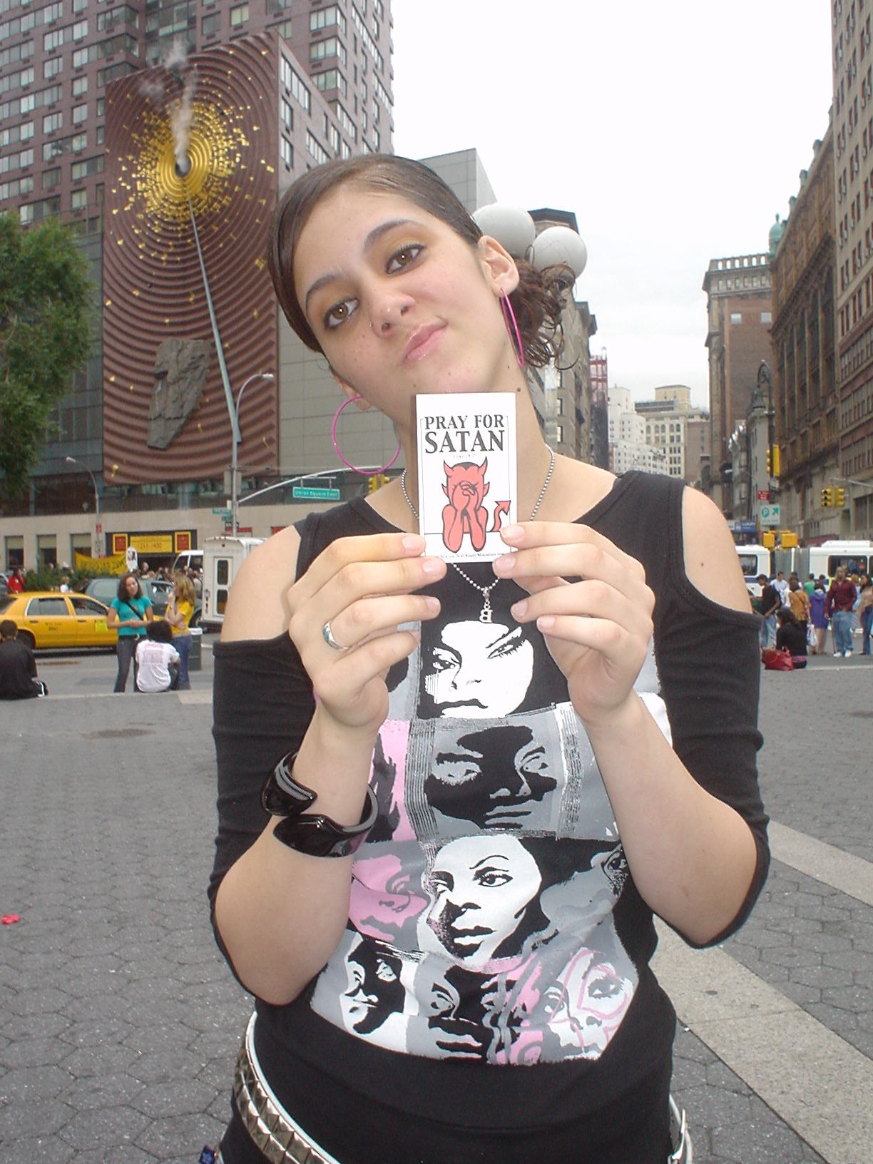 hood rat holding one of my PRAY FOR SATAN flyers