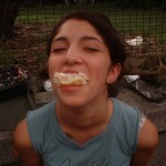 girl with mouthful of cake